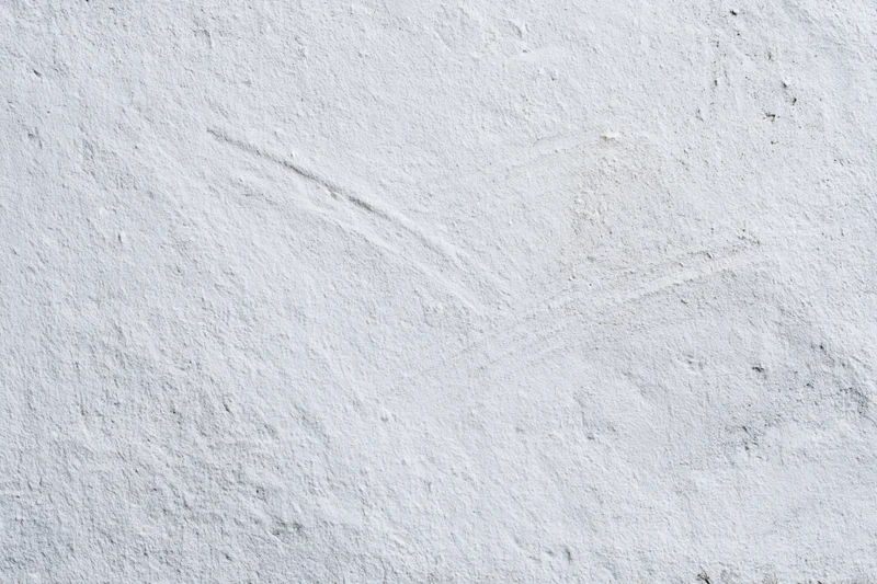 Close-up of a white plastered concrete wall with rough uneven texture