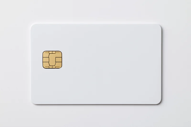 Blank white credit card with gold emv chip on plain white background