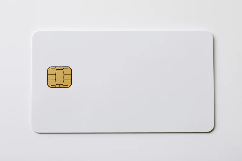 Blank white credit card with gold emv chip on left side isolated on white background