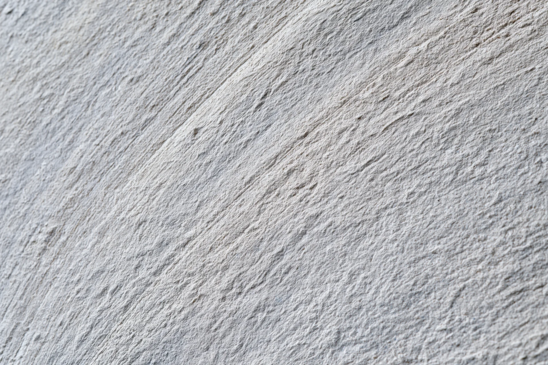 Close-up of rough concrete wall surface with visible texture and grain