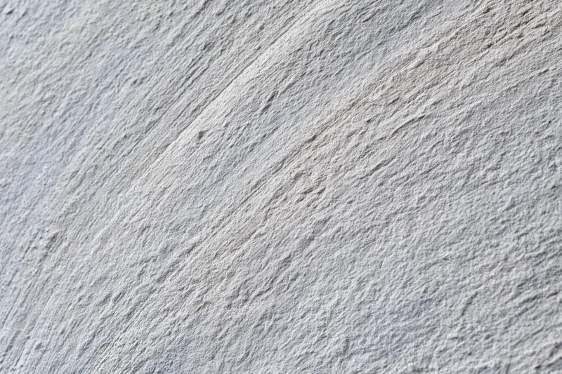 Close-up of rough concrete wall surface with visible texture and grain