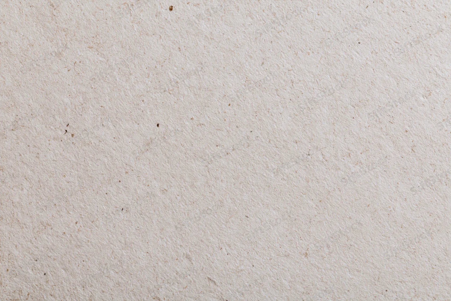 Close-up of a sheet of recycled kraft paper with visible fibers and natural texture filling the frame