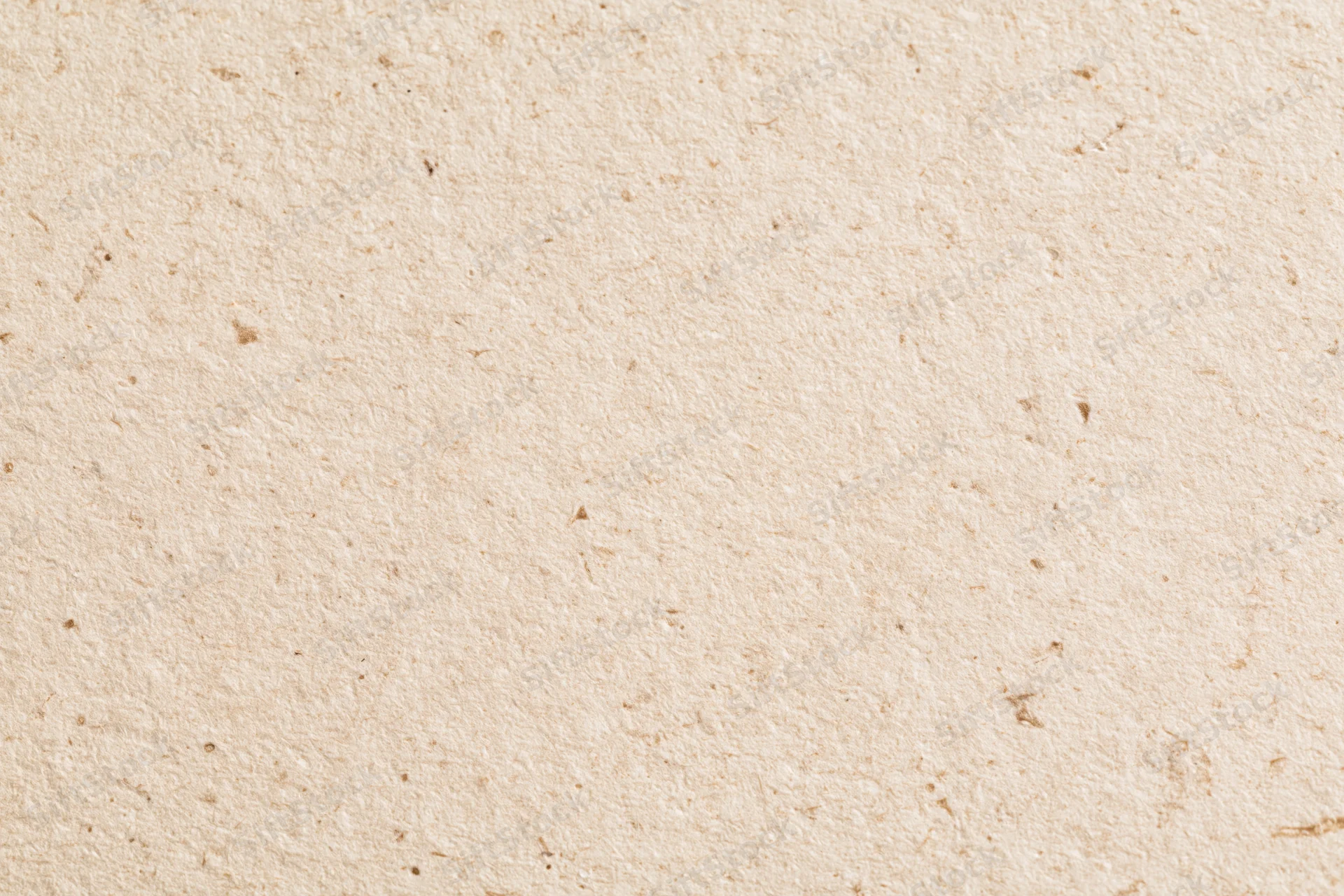 Close-up of a sheet of recycled kraft paper with visible fibers and natural texture filling the frame