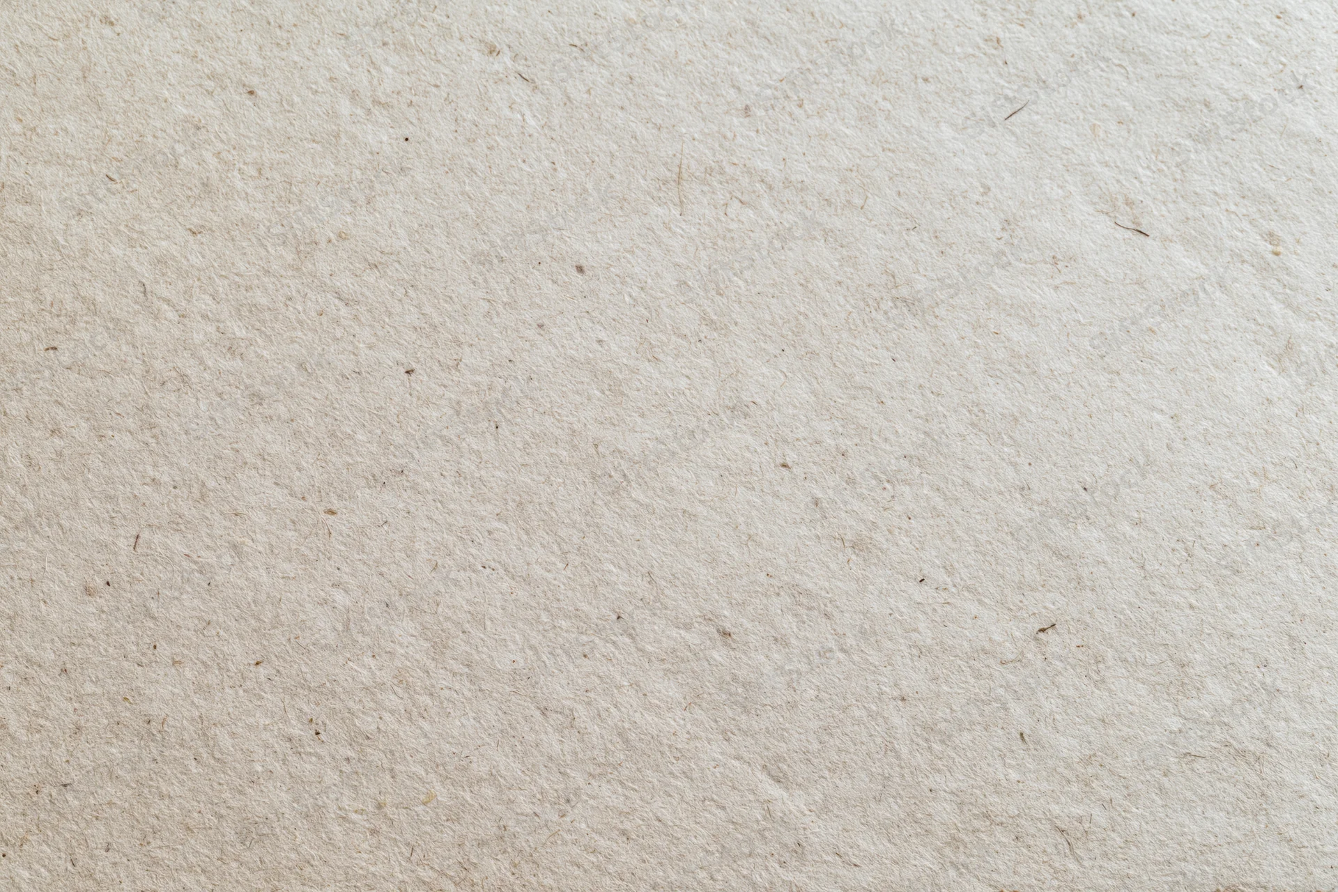 Close-up flat lay of a sheet of recycled kraft paper filling the frame with natural fiber texture