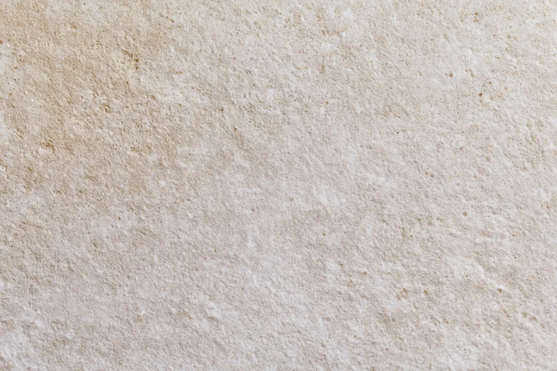 Close-up of smooth beige concrete wall surface with subtle texture and natural grain