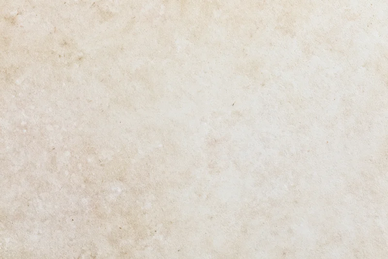 Close-up of smooth beige concrete wall surface with subtle texture and mottled finish