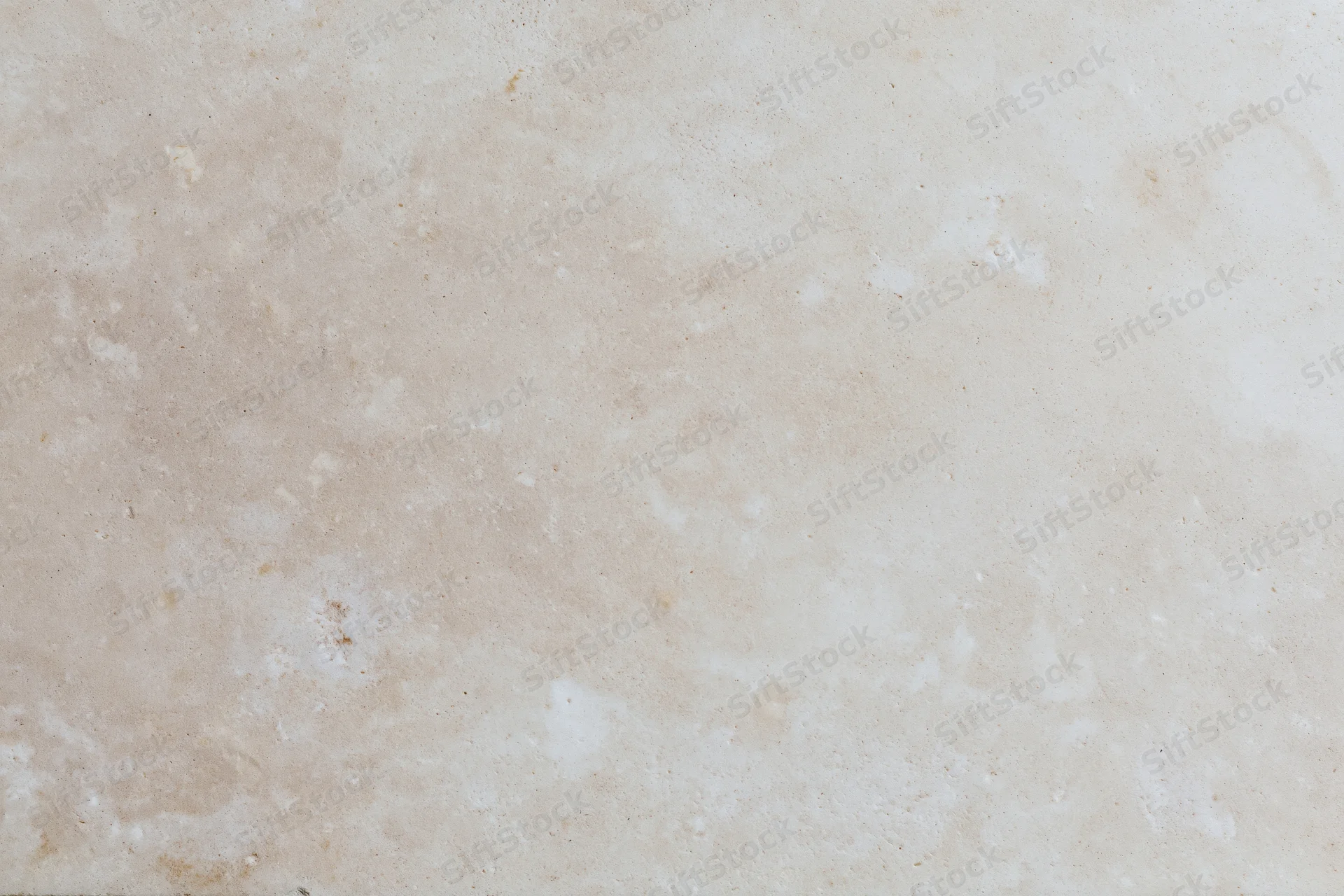 Close-up of smooth beige concrete wall surface with subtle texture and neutral tone