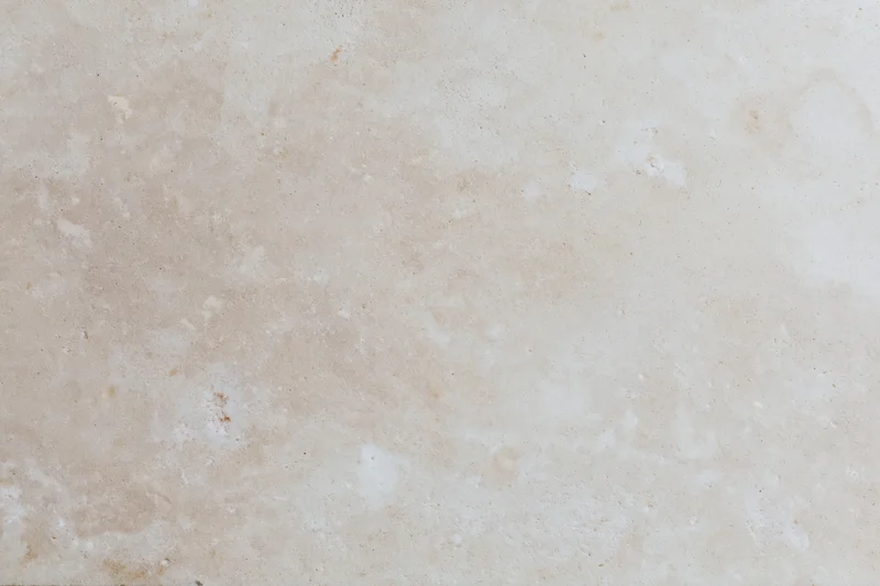 Close-up of smooth beige concrete wall surface with subtle texture and neutral tone