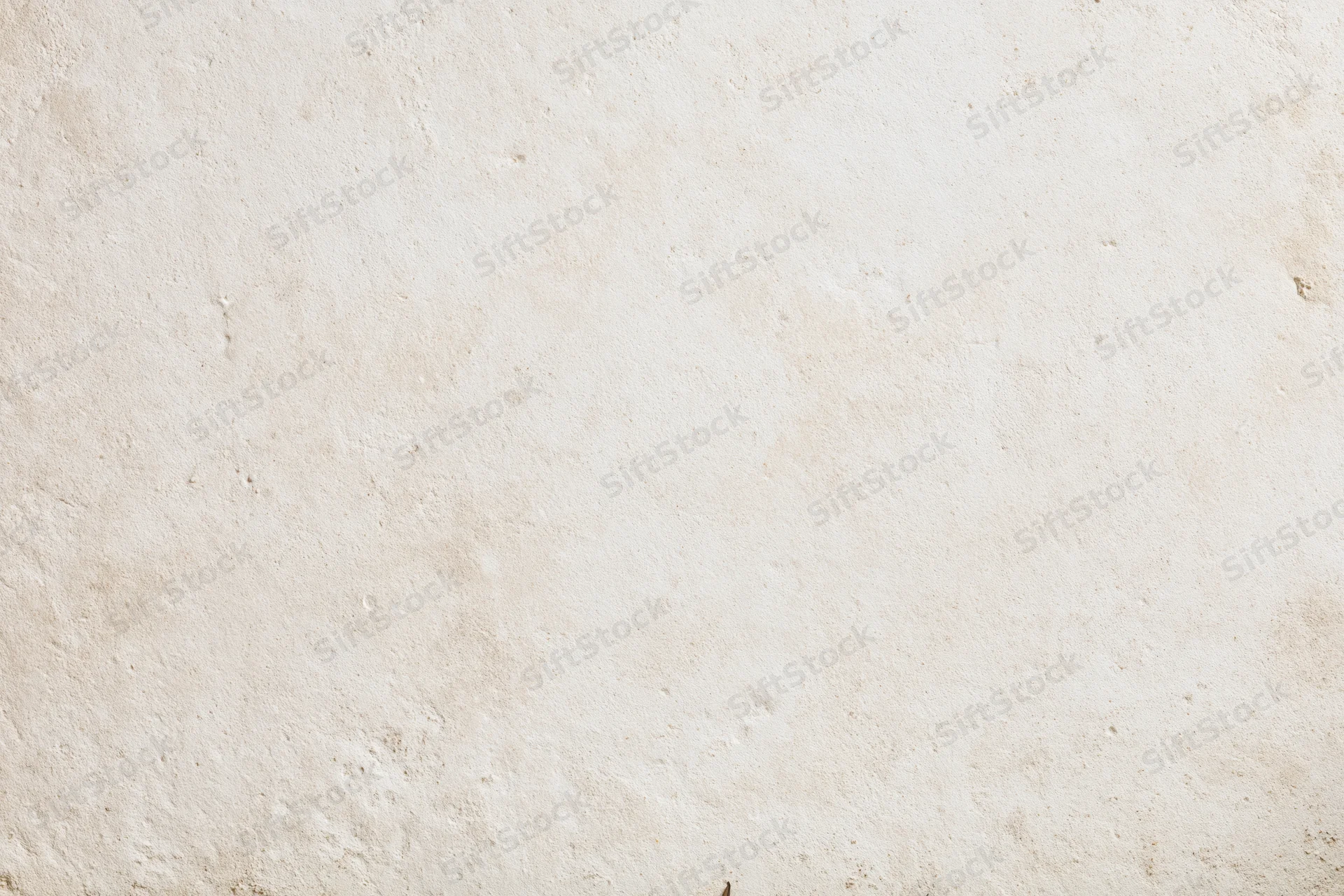Close-up of a smooth beige plaster wall surface with subtle texture and natural imperfections