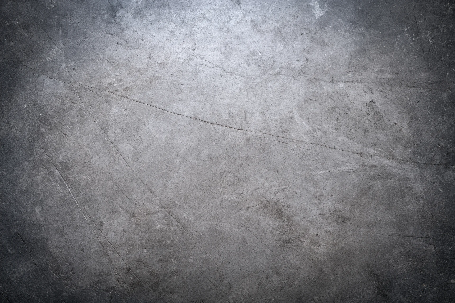 Close-up of a weathered concrete wall surface with cracks and scratches, showing texture and grunge details