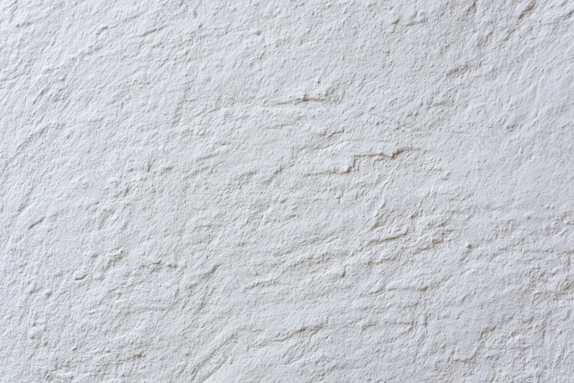 Close-up of white plaster wall surface with textured finish