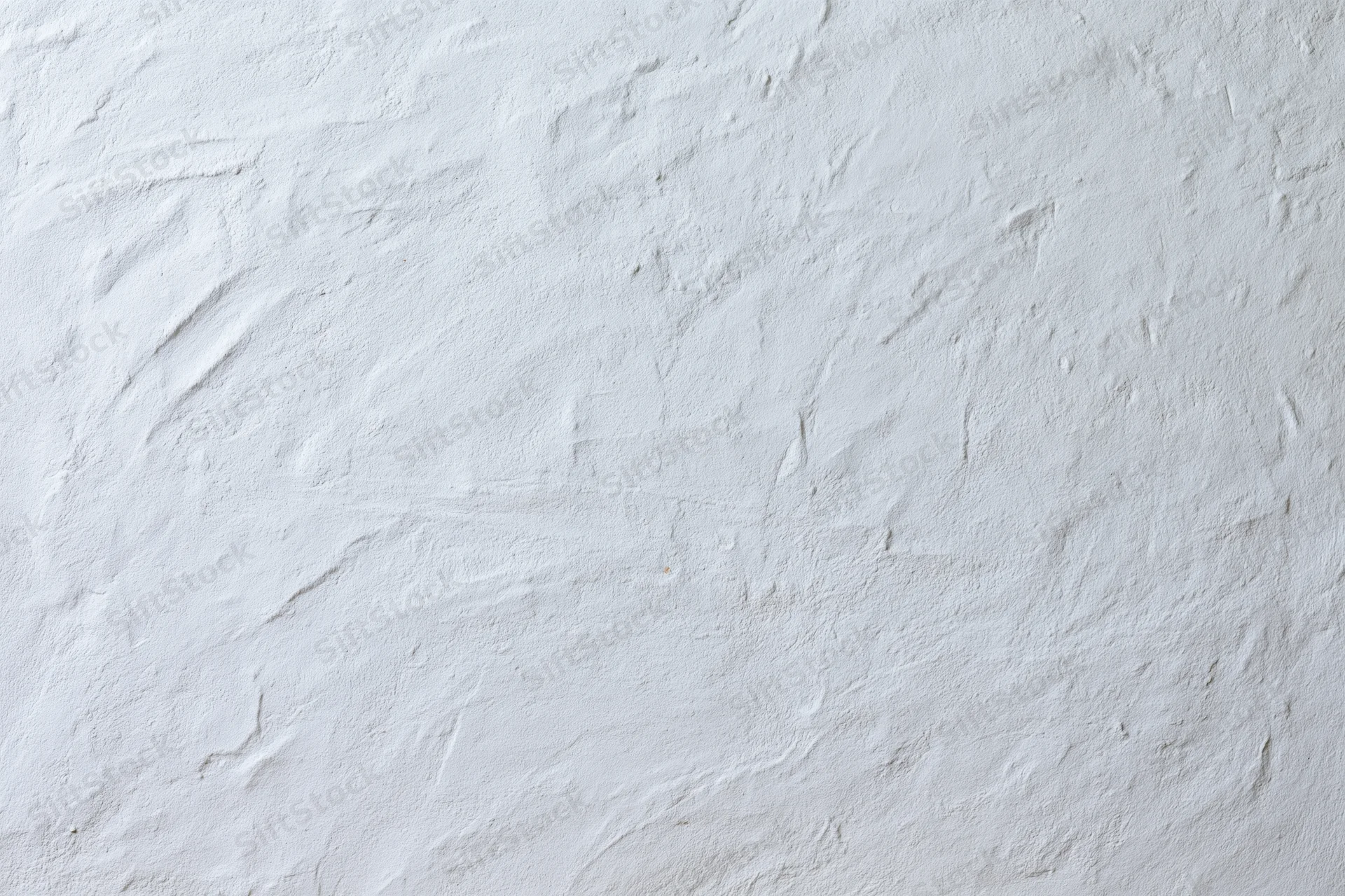 Close-up of white plastered wall surface with rough texture