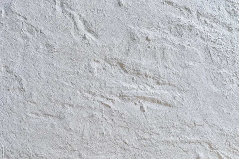 Close-up of a white plastered wall surface with rough texture