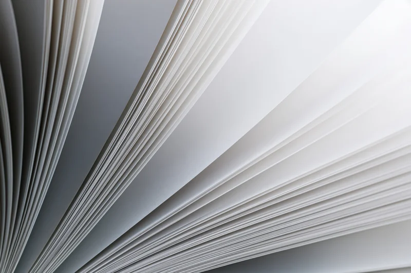 Fanned open book pages curving outward in close-up macro view