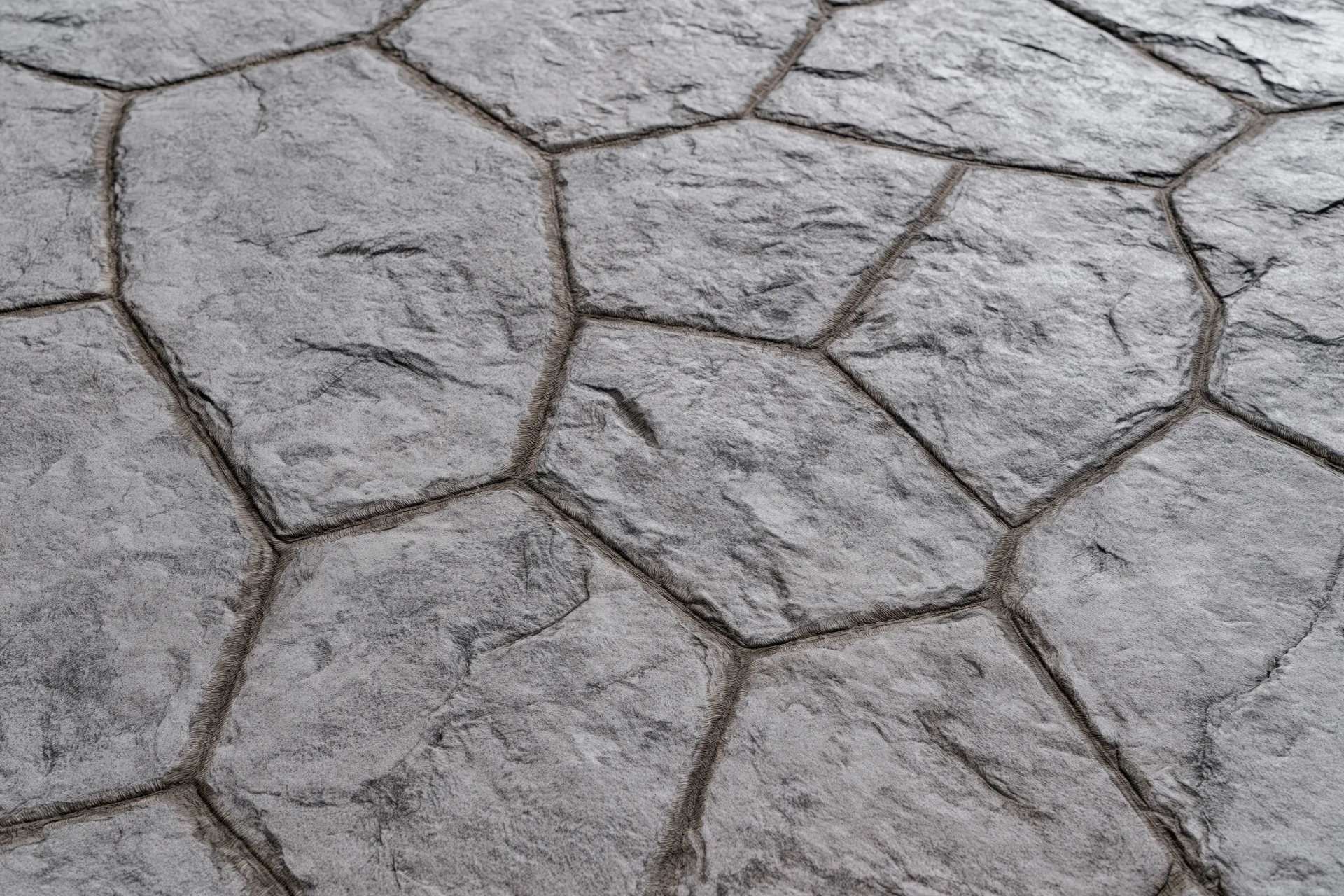 Close-up of stamped concrete pavement with irregular hexagonal pattern and textured surface