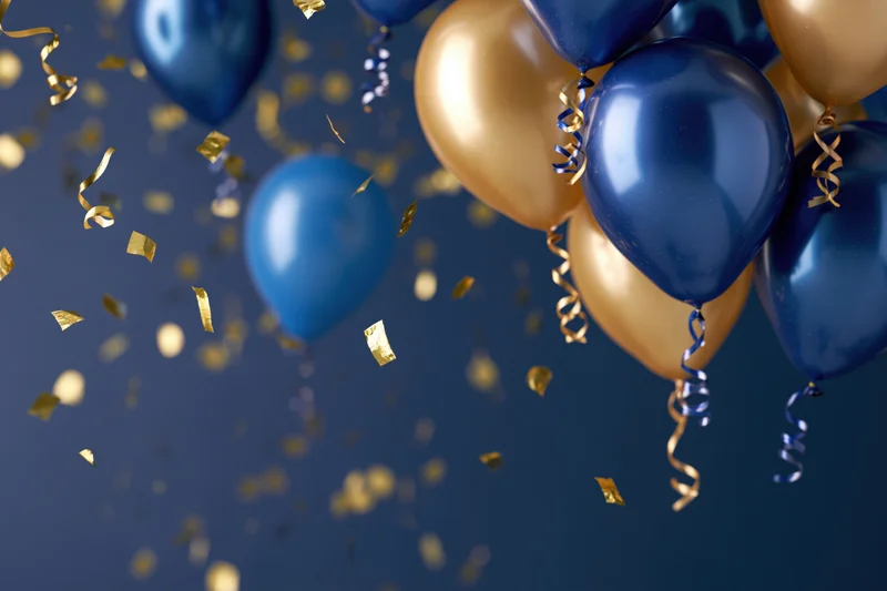 Cluster of metallic blue and gold balloons bunched together