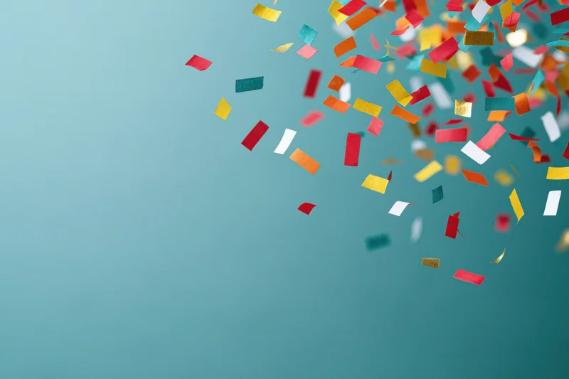 Colorful paper confetti falling across a teal background with copyspace on the left