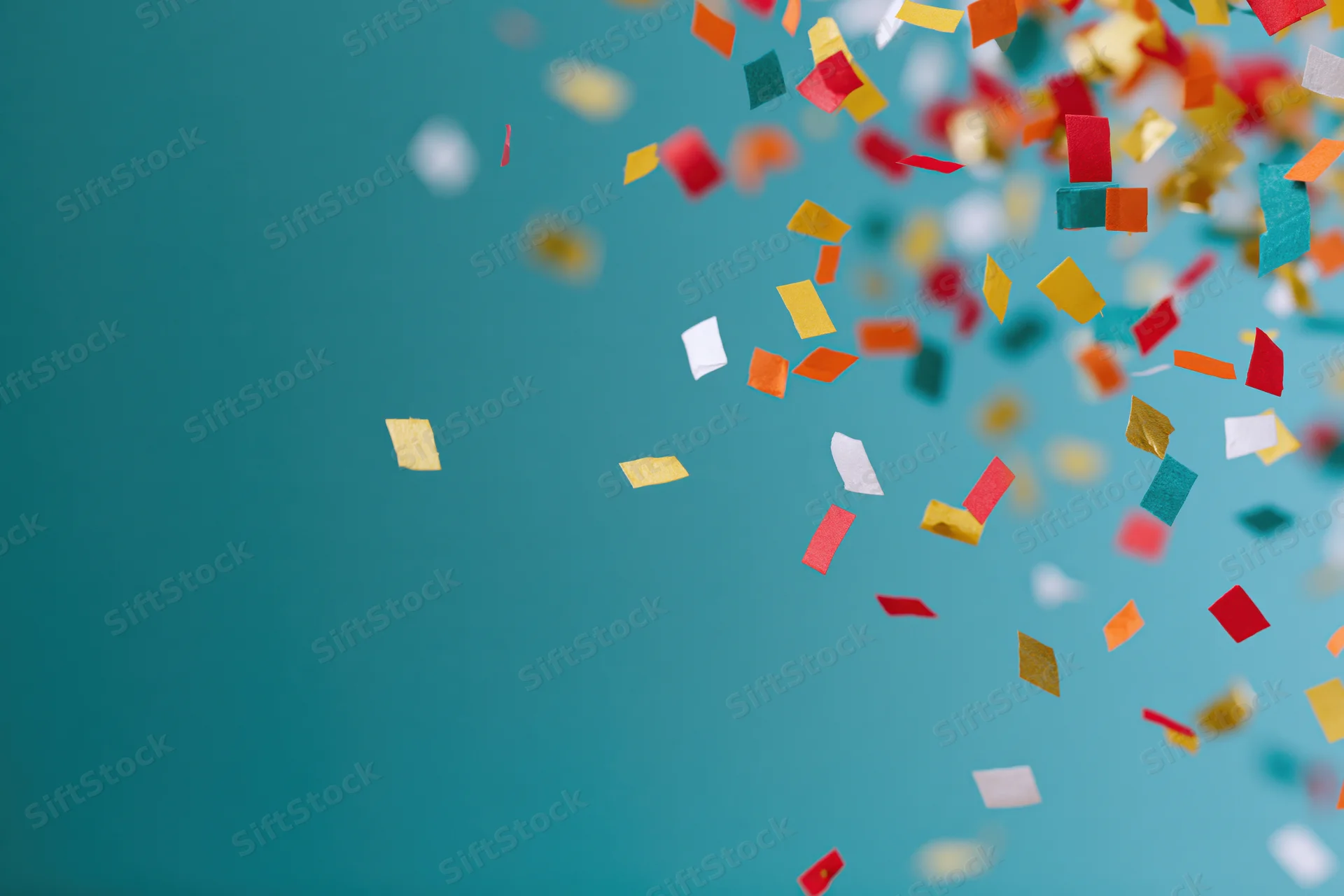 Colorful paper confetti pieces falling across teal background with copyspace on left