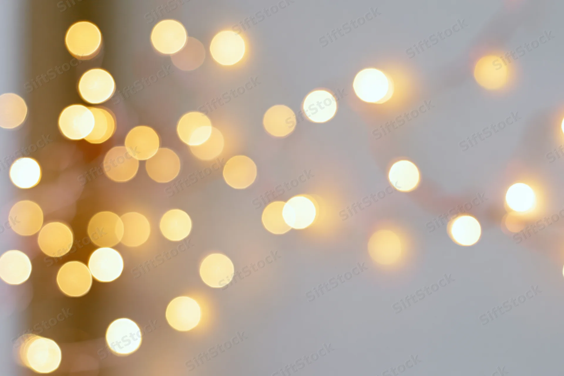 Warm glowing fairy lights out of focus against a soft background