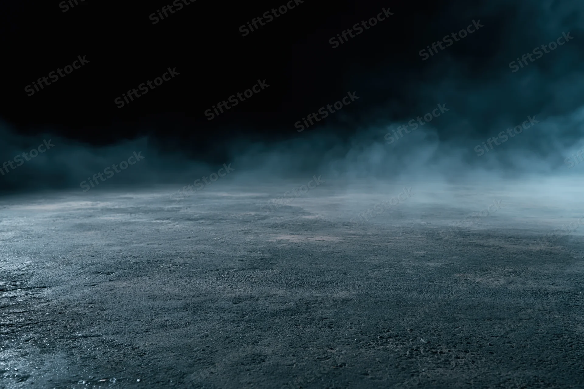 Dark concrete floor with low-lying smoke drifting across the surface