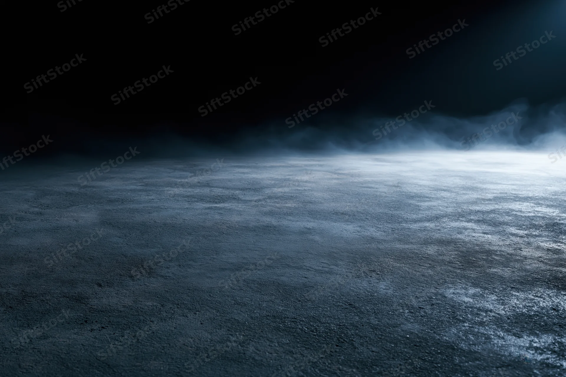 Dark concrete floor with drifting smoke in dim industrial space