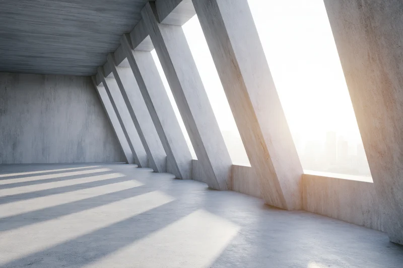 Empty raw concrete interior with diagonal beams and windows letting in sunlight