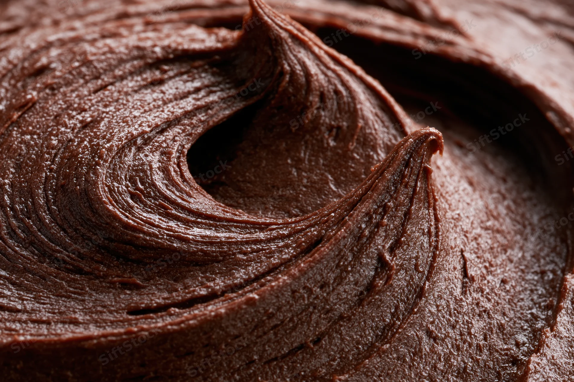 Close-up of dark chocolate buttercream frosting swirl
