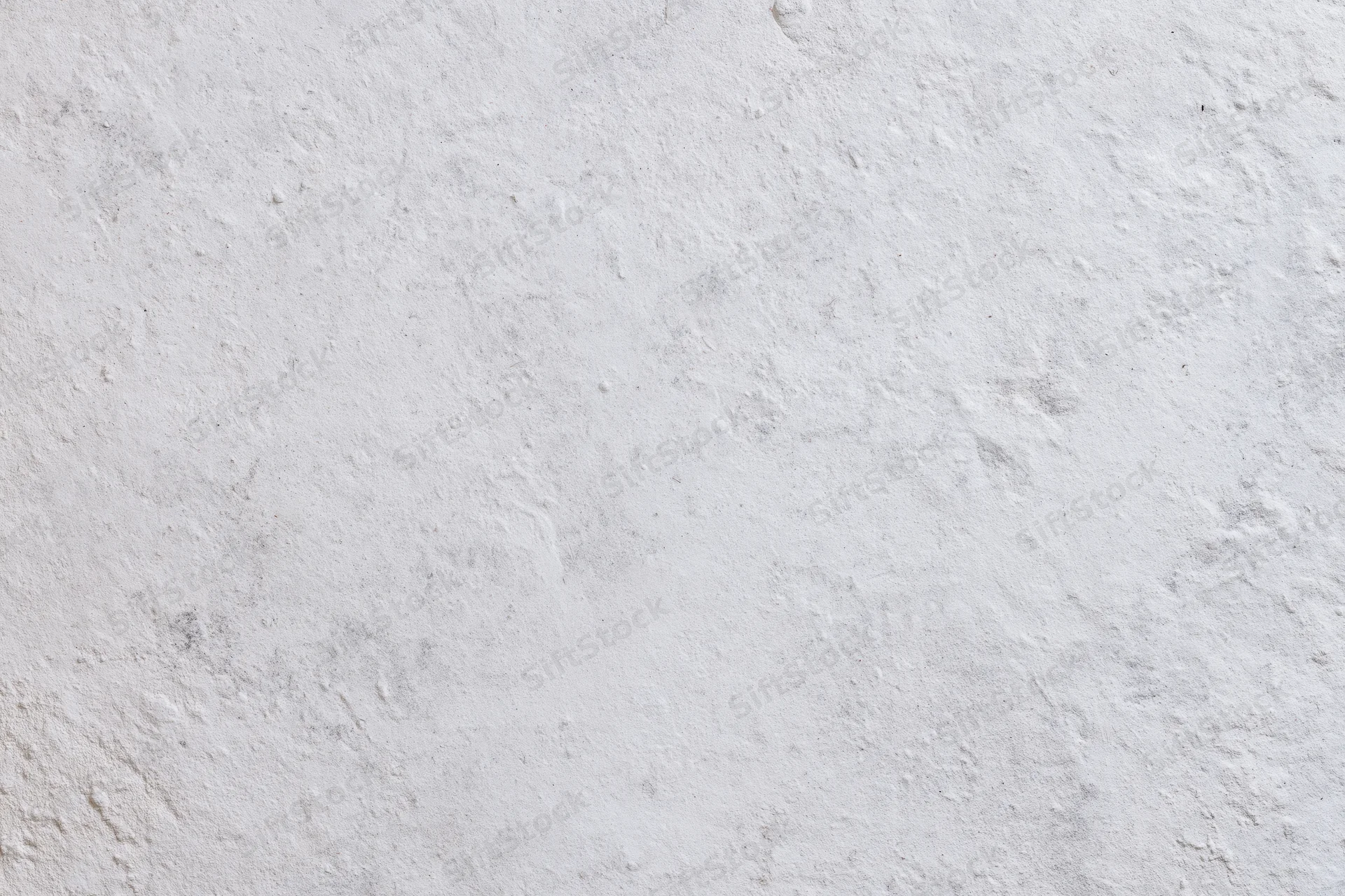 Closeup of a textured white concrete wall surface filling the frame