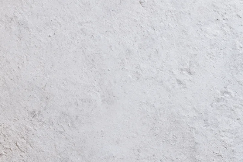 Closeup of a textured white concrete wall surface filling the frame