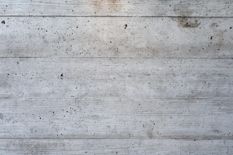 Flat concrete wall surface with horizontal lines and weathered texture filling the frame