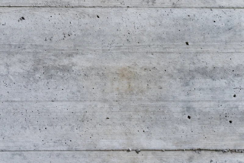 Flat concrete wall surface with horizontal panels and weathered texture