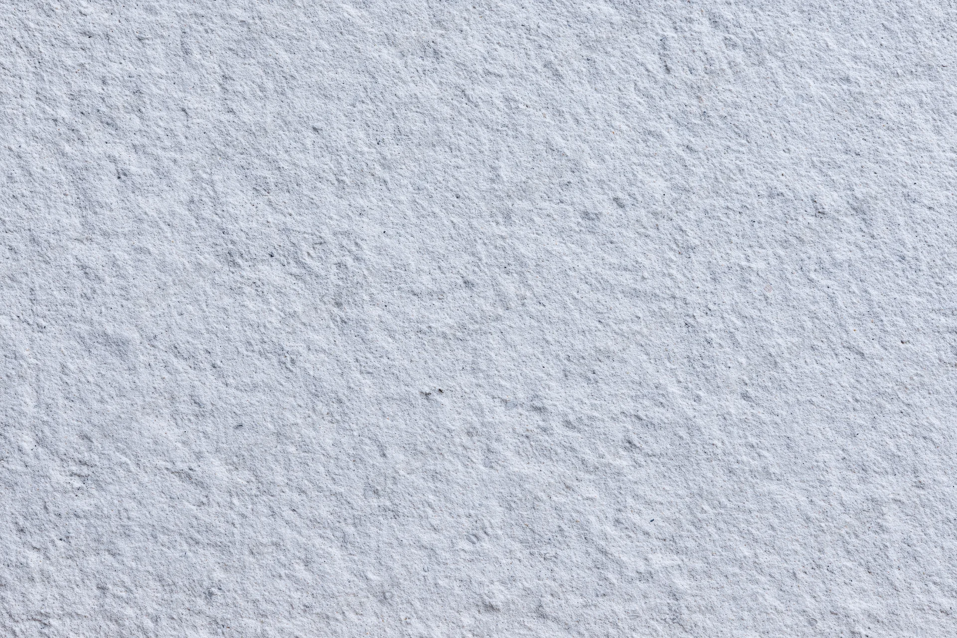 Close-up of a rough gray concrete wall surface filling the frame