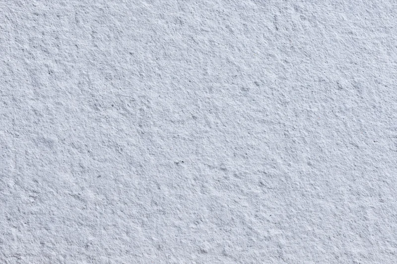 Close-up of a rough gray concrete wall surface filling the frame