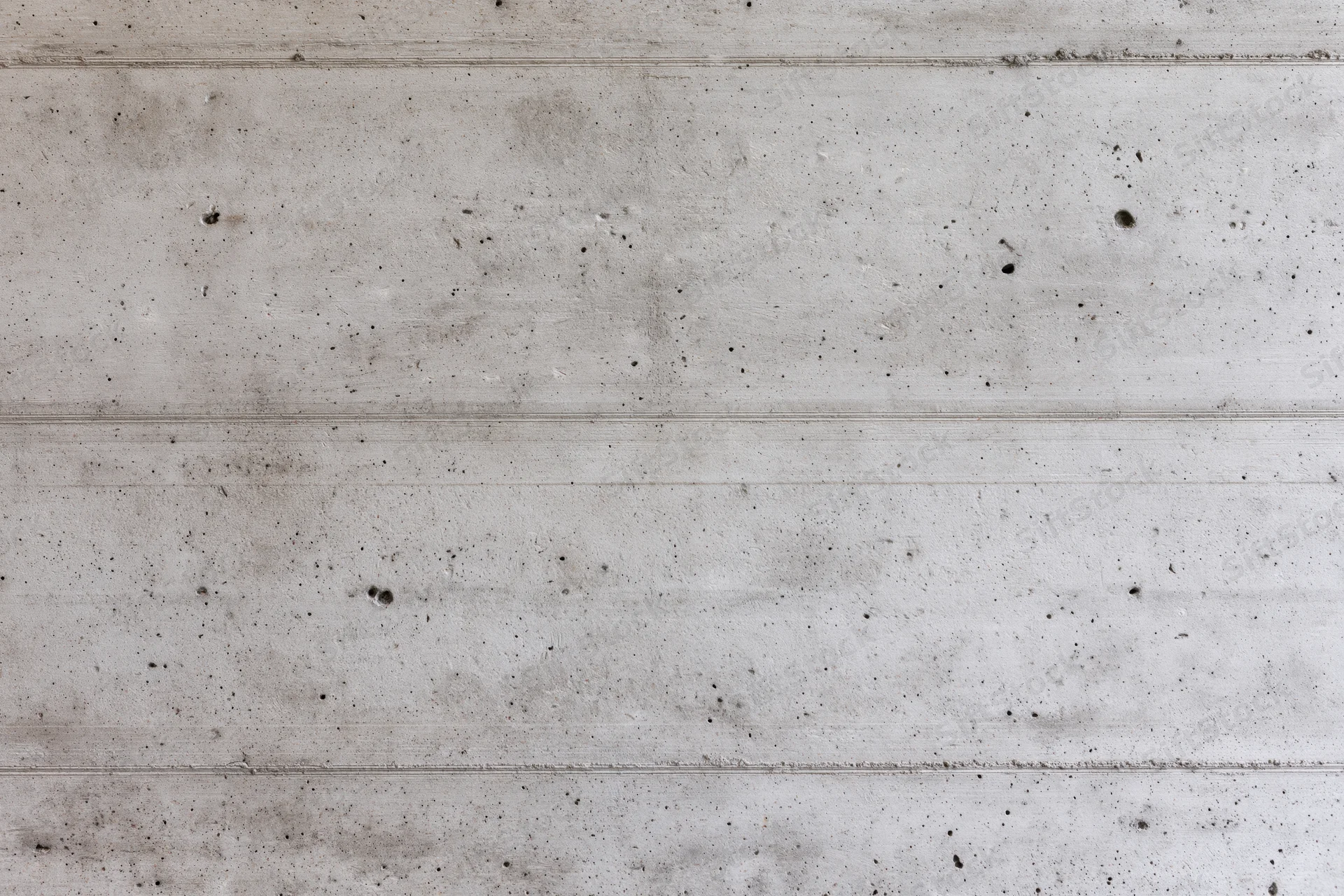 Flat concrete wall surface with horizontal lines and speckled texture filling the frame