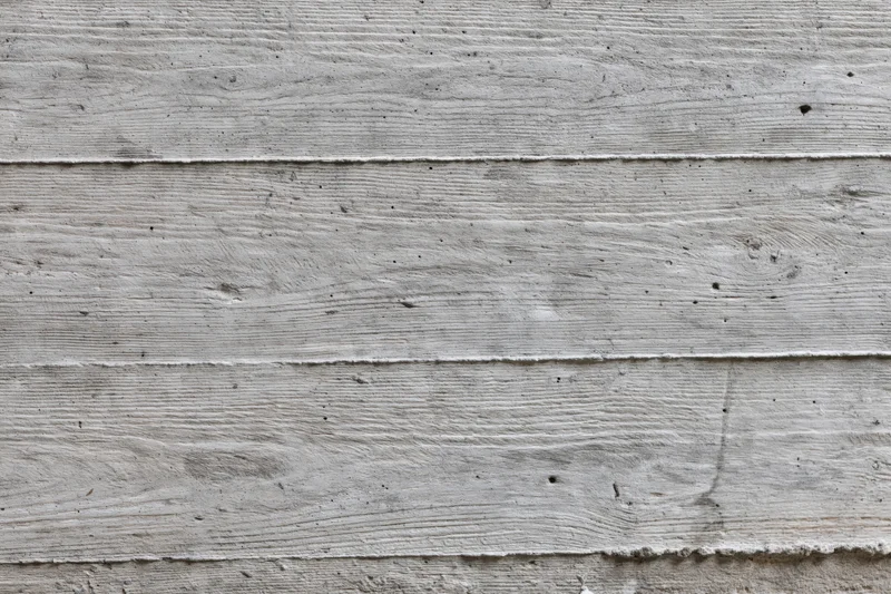 Horizontal formwork lines on a gray concrete wall surface