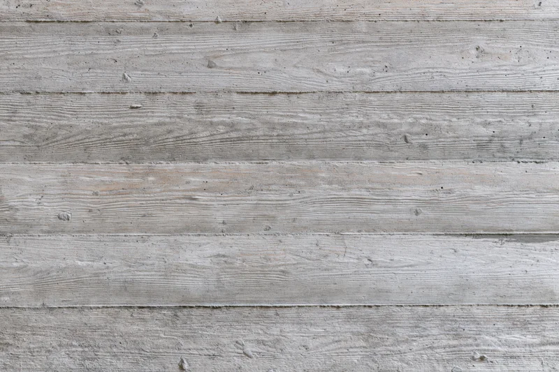 Horizontal formwork lines on a gray concrete wall surface