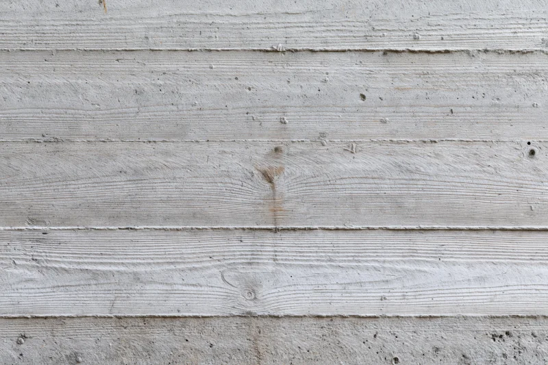 Horizontal formwork lines on a gray concrete wall surface