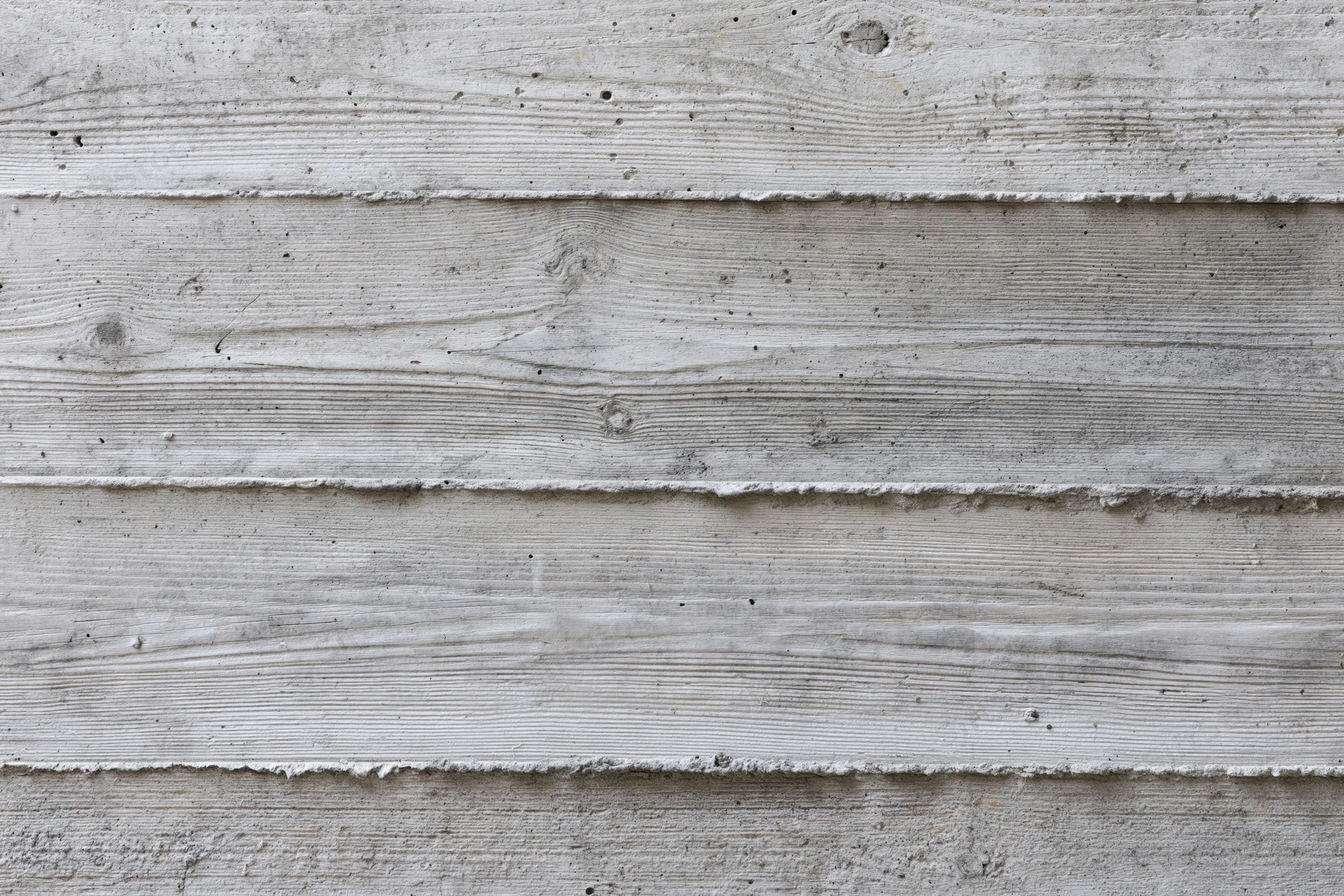 Flat concrete wall with horizontal formwork lines and textured surface