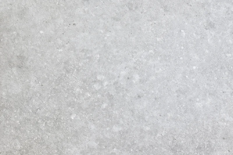 Close-up of smooth grey concrete surface with subtle texture and speckles