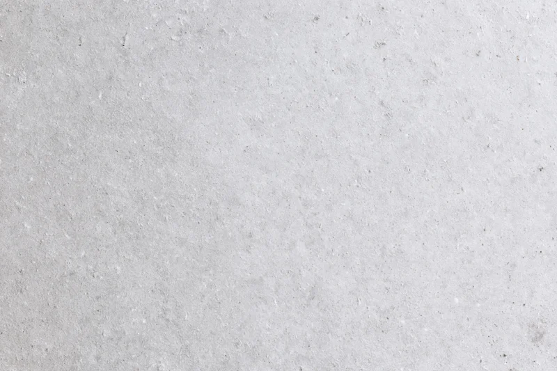 Close-up of smooth grey concrete surface with subtle texture and speckles