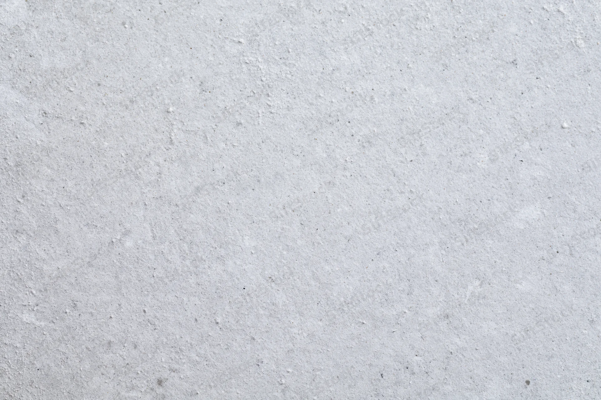 Close-up of smooth grey concrete surface with fine texture and speckles