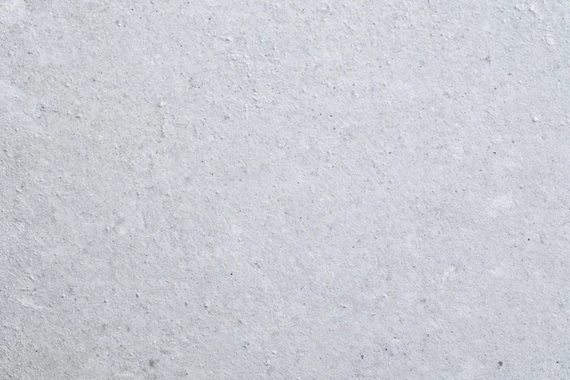 Close-up of smooth grey concrete surface with fine texture and speckles