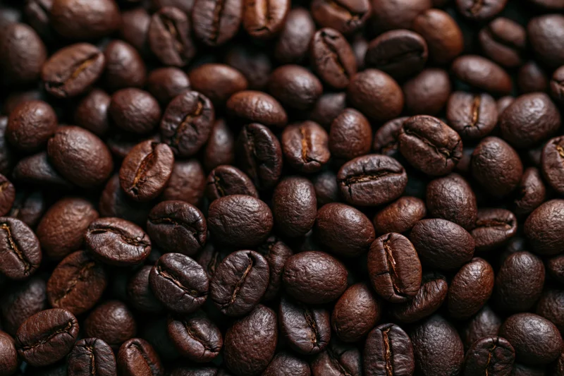 Closeup of dark roasted coffee beans filling the frame