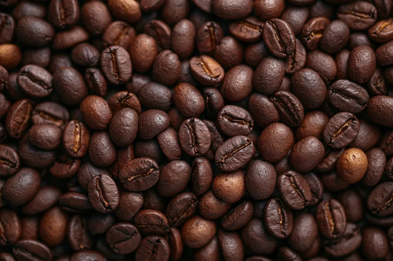 Dark roasted coffee beans filling the frame in a close-up view