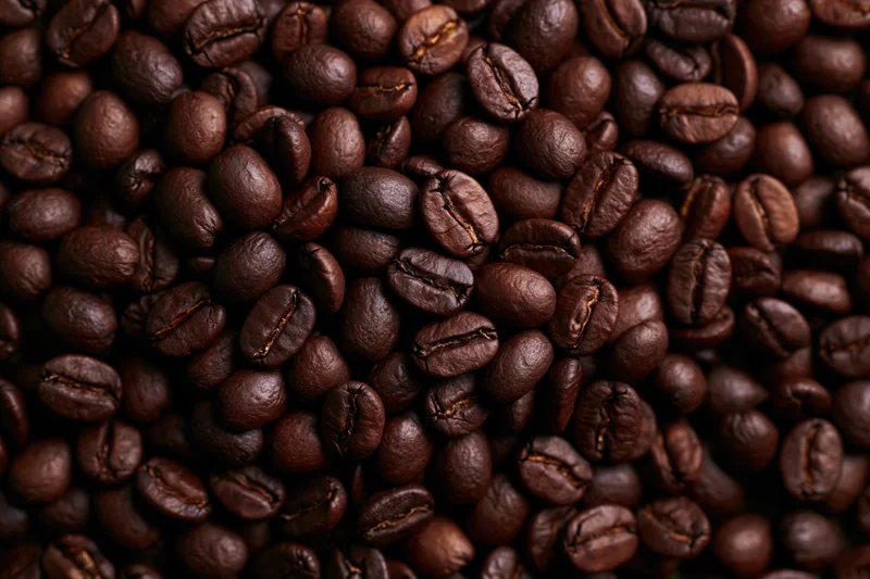 Closeup of dark roasted coffee beans filling the frame