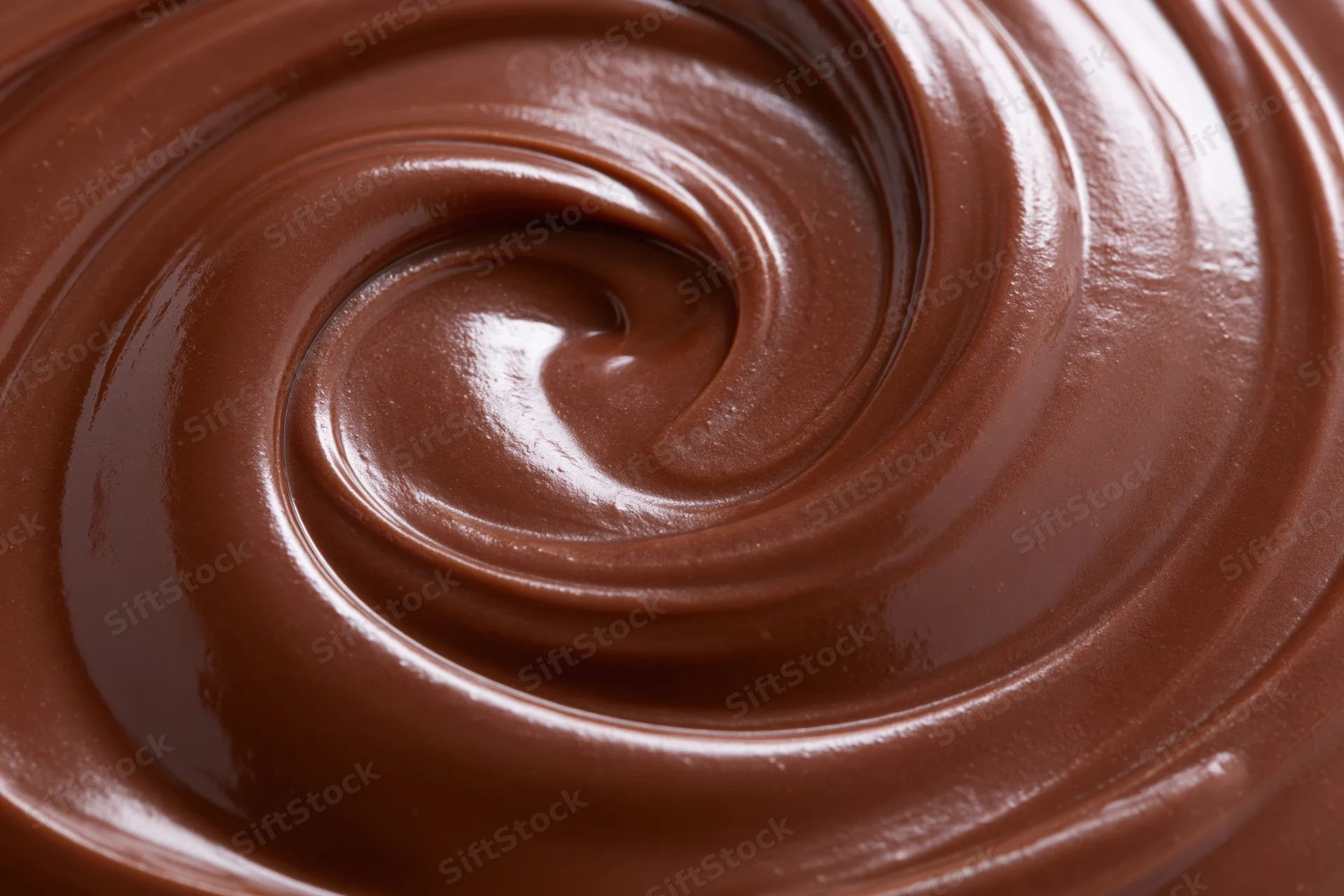 Melted dark chocolate swirled into a smooth spiral pattern