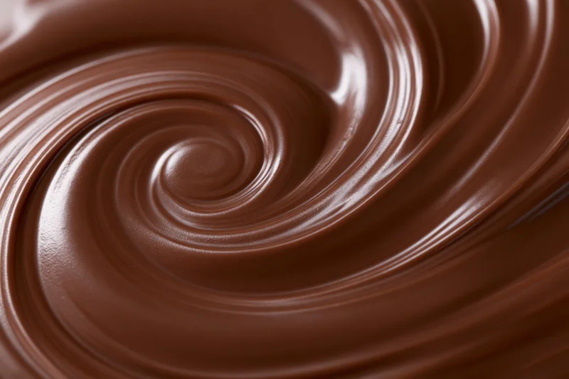 Melted dark chocolate swirled into a smooth spiral pattern
