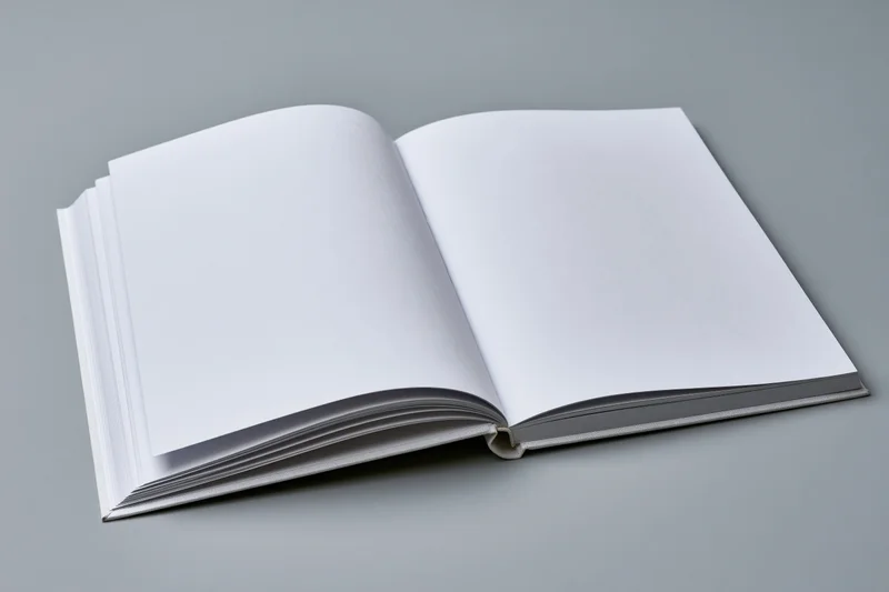Open hardcover book with blank white pages on gray surface