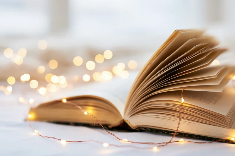 Open hardcover book with pages fanned and resting on a surface