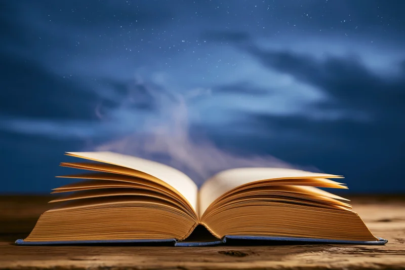 Open hardcover book with yellowed pages on wooden table under starry night sky emitting wisps of smoke